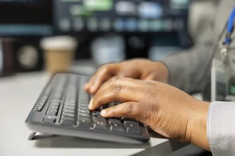 Close up of server room software developer doing data backup, typing on PC Stockfoto's