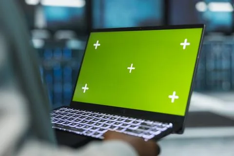Close up of server room technician using chroma key laptop to repair gear 스톡 사진
