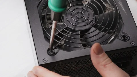 Close up of a service worker disassembles a PC power supply for cleaning and 库存影片 105590617