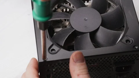 Close up of a service worker disassembles a PC power supply for cleaning and Stock Footage 105590851