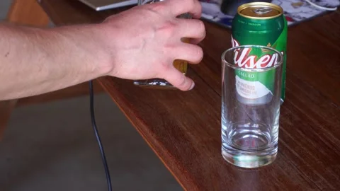 Close-up serving a can of Pilsen beer in a glass in the morning after a night of 스톡 동영상 199586846