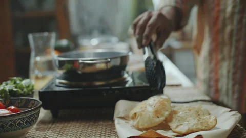 Close-Up of Serving Freshly Fried Indian Puris on Plate in Kitchen Stock Footage 303020161