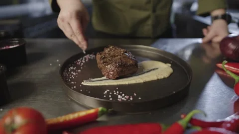 Close-up of serving salt on a plate with steak. Stock Footage 240300653