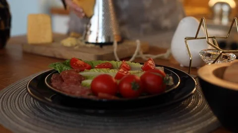 Close up serving table with fresh vegetable salad on plate. Grate cheese on Stock Footage 127110057
