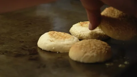 Close up sesame seed bread buns placed on stove Stock Footage 91371462