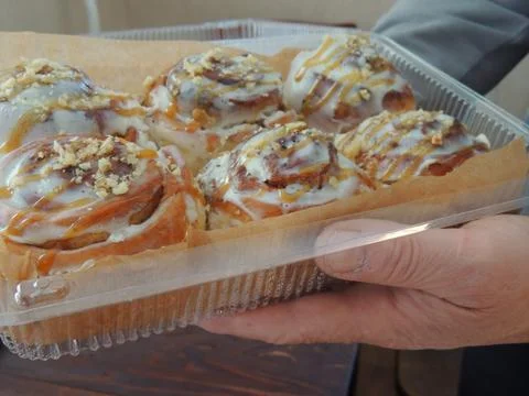 A close-up of a set of cinabons in hands 스톡 사진