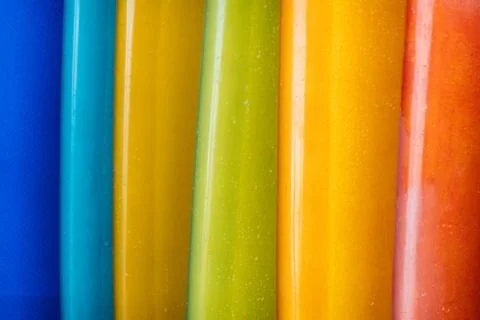 Close up Set of different color surf boards in a stack on sandy beach for ren Stockfoto's