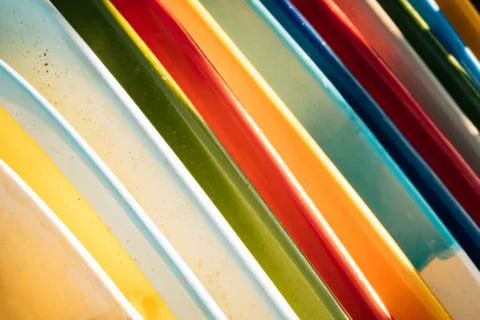 Close up Set of different color surf boards in a stack on sandy beach for ren Stockfoto's