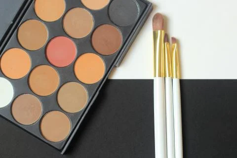 Close up. .a set of eye shadow and two brushes on black and white background Stock Photos