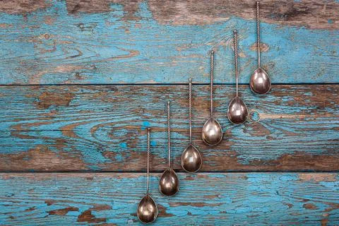Close up of set of spoons on old blue wooden board Free Stock Photos