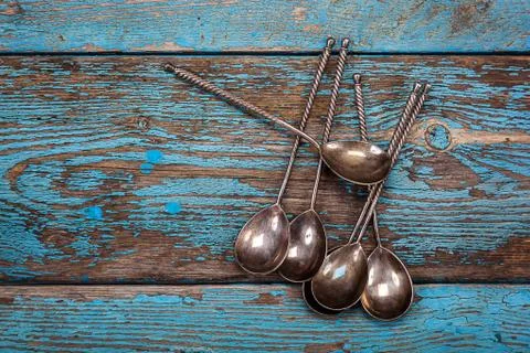 Close up of set of spoons on old blue wooden board Free Stock Photos