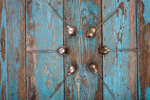 Close up of set of spoons on old blue wooden board Free Stock Photos