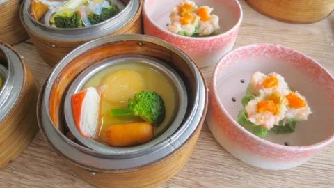 Close up of set steamed dim sum dumplings in basket, chinese traditional food Stock Photos
