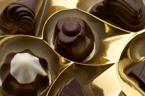Close-up of several assorted chocolates in a yellow packing box Stock Photos