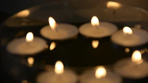 Close up of several floating candles in a glass of water. Beautiful candle light 스톡 동영상 163079239