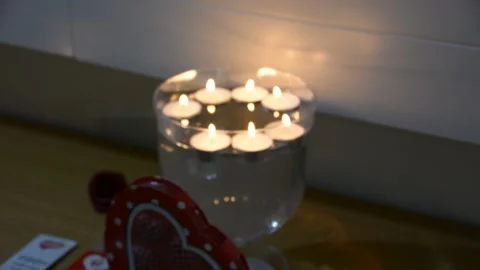 Close up of several floating candles in a glass of water. Beautiful candle light 스톡 동영상 163079308