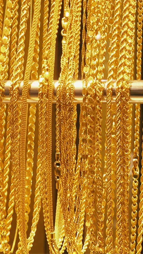 Close-up of several gold chains hanging on a jewelry bar Stock Footage 337448297