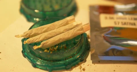 Close up several rolled joints on grinder Stock Footage 122177556