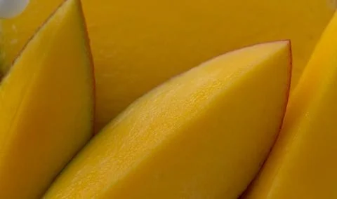 A close-up of several slices of ripe mango Stock Photos