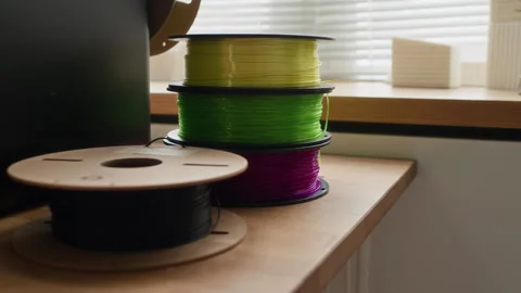 Close up of Several Spools of Multicolored 3D Printing Filament Stock Footage 335688939