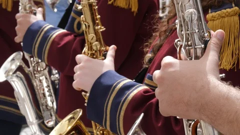 Close up of several unrecognizable saxophone marching band members playing in a Stock Footage 92061886