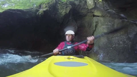 CLOSE UP: Several waterfall drops with kayak through the crack in mountain wall Stock Footage 71844770