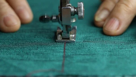 Close-up of sewing green fabric with old sewing machine Stock Footage 110849994