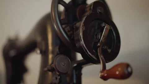 Close up sewing machine crank handle, chipped paint and textured metal, wooden Stock Footage 346546432