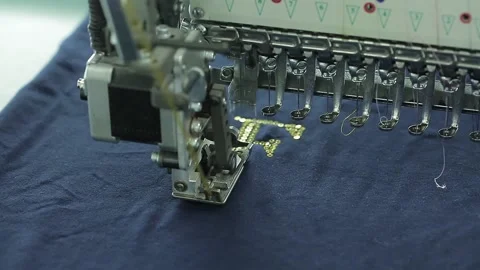 Close-up of a sewing machine embroidery sequins on fabric. Clothing production Stock Footage 136376020