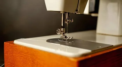 Close-up of sewing machine needle and fabric in workshop 스톡 사진