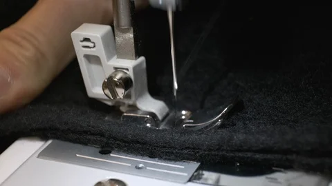 Close-up of sewing machine needle moves up and down. Black fabric Stock Footage 114623169