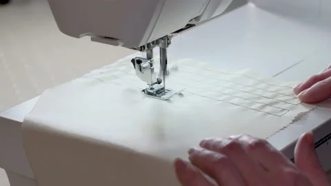 Close-up of a sewing machine needle moving rapidly up and down. In a sewing Stock Footage 141919504