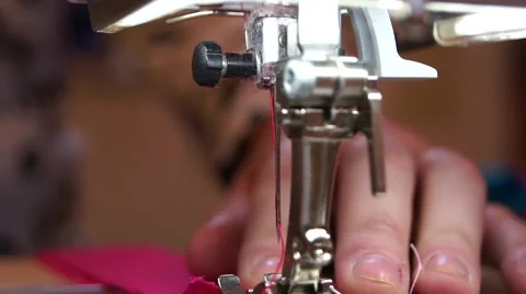 Close up sewing machine needle with pink thread in action Stock Footage 43666424