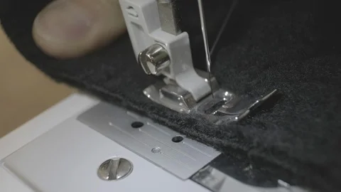 Close-up of sewing machine needle rapidly moves up and down. Black fabric Stock Footage 113923152