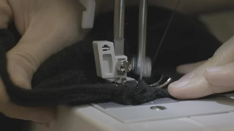 Close-up of sewing machine needle rapidly moves up and down. Black fabric Stock Footage 114620962