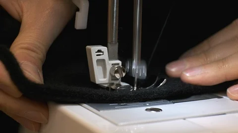Close-up of sewing machine needle rapidly moves up and down Stock Footage 114621397
