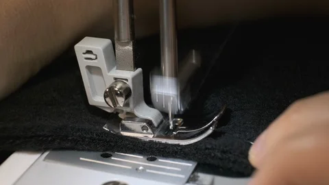 Close-up of sewing machine needle rapidly moves up and down. Black fabric Stock Footage 126618680
