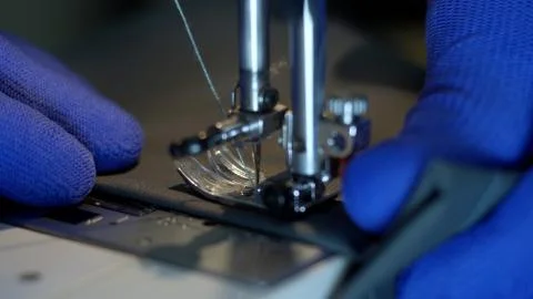 Close-up of sewing machine needle rapidly moves up and down. Stock Photos