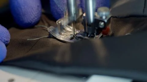 Close-up of sewing machine needle rapidly moves up and down. 写真素材