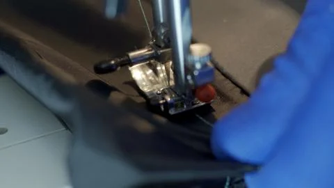 Close-up of sewing machine needle rapidly moves up and down. Stock Photos
