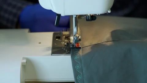 Close-up of sewing machine needle rapidly moves up and down. Stock Photos
