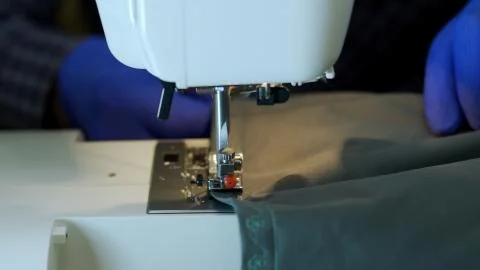 Close-up of sewing machine needle rapidly moves up and down. Stock Photos