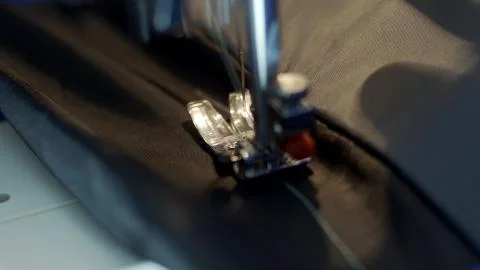 Close-up of sewing machine needle rapidly moves up and down. Stock Photos