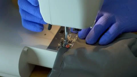 Close-up of sewing machine needle rapidly moves up and down. Stock Photos