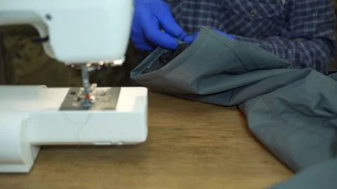 Close-up of sewing machine needle rapidly moves up and down. Stock Photos