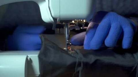 Close-up of sewing machine needle rapidly moves up and down. 스톡 사진