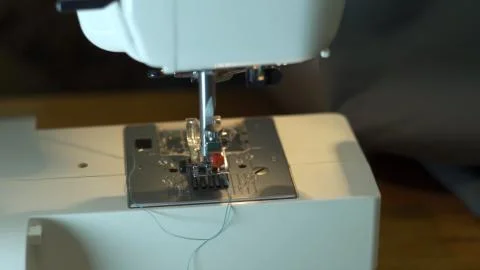 Close-up of sewing machine needle rapidly moves up and down. Stock Photos