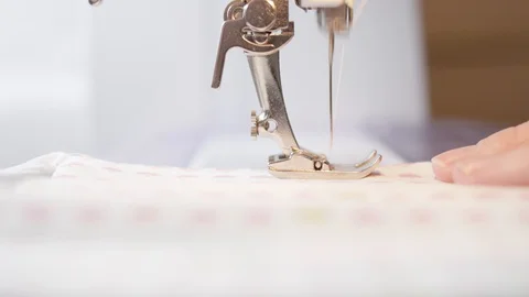Close-up of sewing machine needle running over fabric Stock Footage 128149571