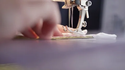 Close-up of sewing machine needle running over fabric in slow motion Stock Footage 128313169