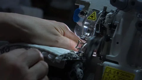 The close-up of the sewing machine needle in slow motion. The seamstress sews Stock Footage 220928049